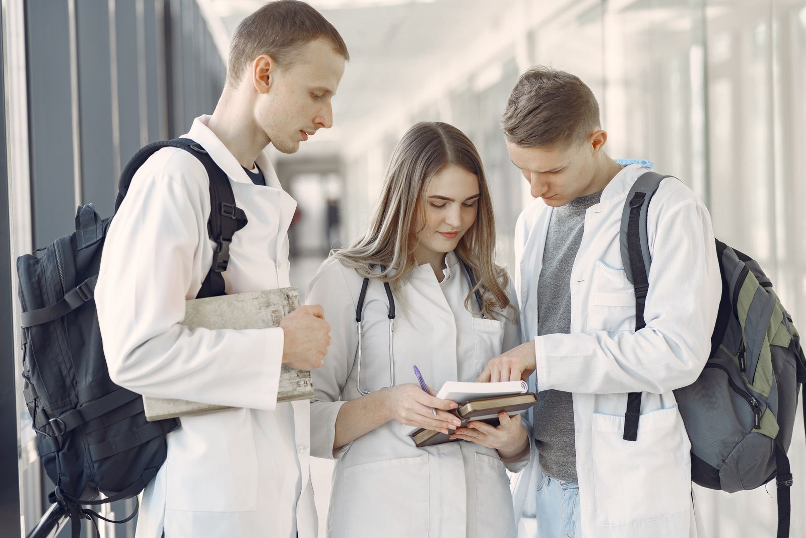 Medical students in white coats discussing notes together in a hospital hallway, reflecting the everyday clinical colleagues described in this Sri Lanka culture guide