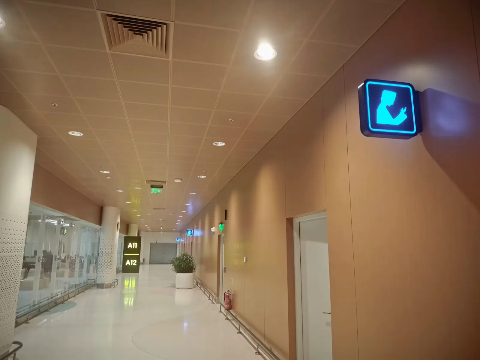 A hospital hallway with a baby changing station sign