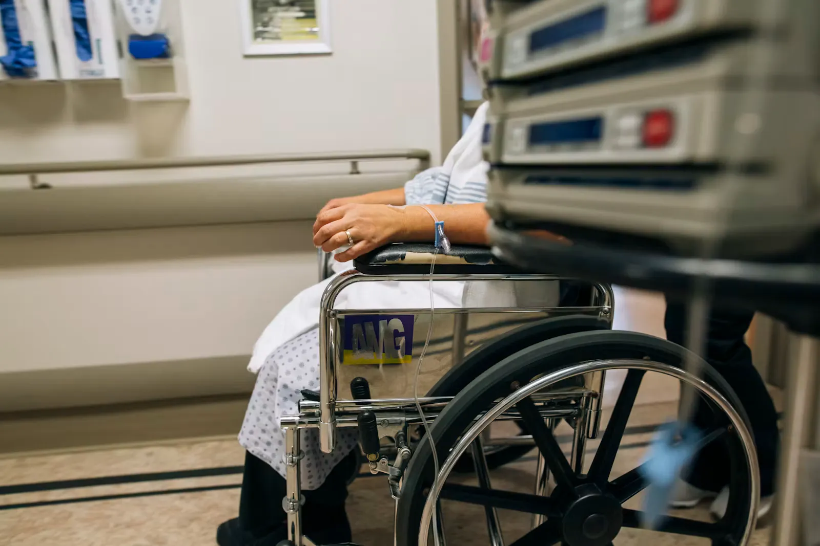 A patient being assisted with a wheelchair in a hospital, representative of clinical rotations during a medical elective in Sri Lanka