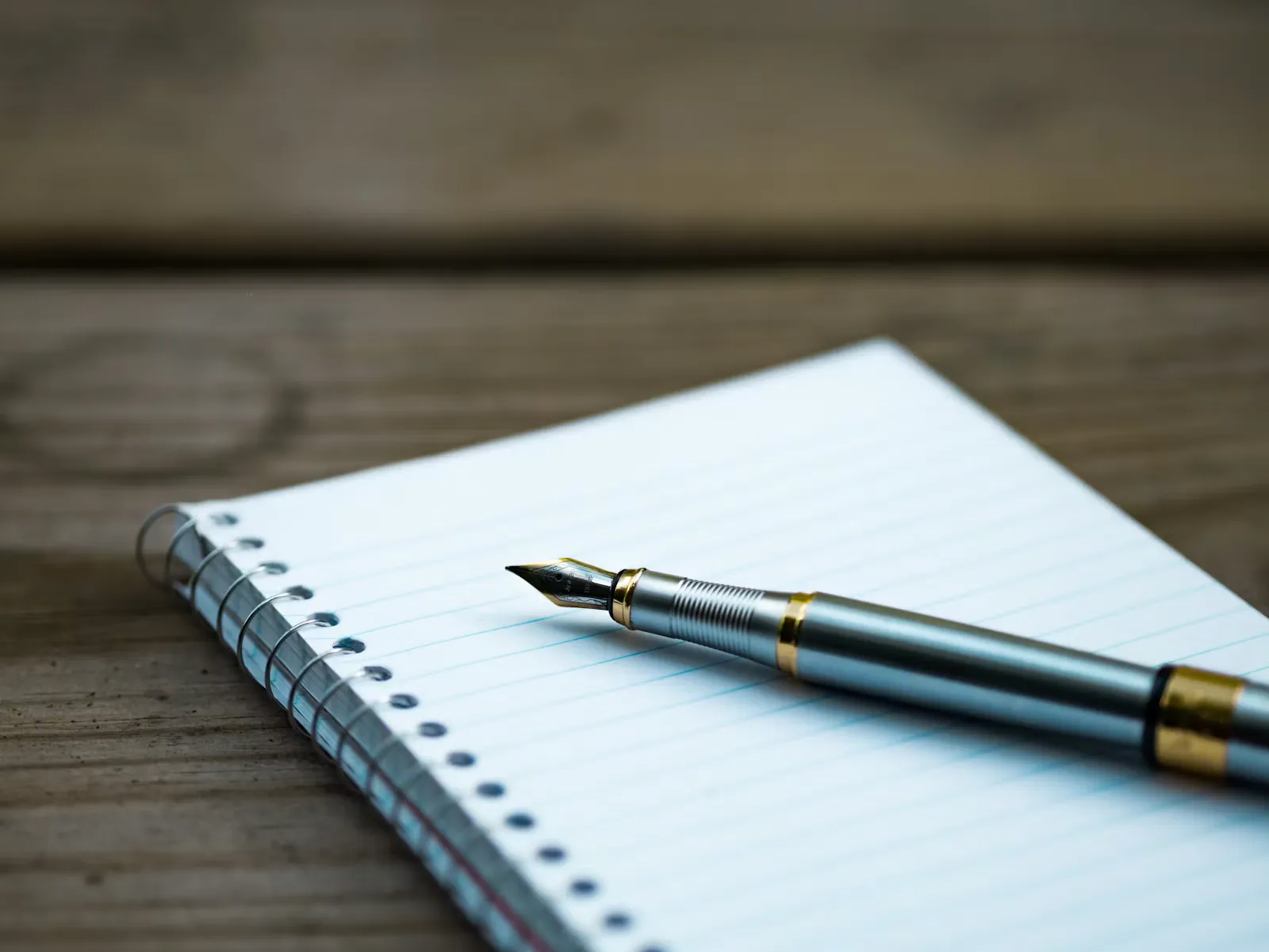 Notebook, pen and coffee on a desk, representing a letter writer drafting an ERAS letter of recommendation
