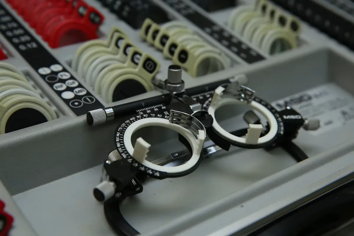 An optometric trial frame resting in a tray of trial lenses, the kind of equipment used in ophthalmology training
