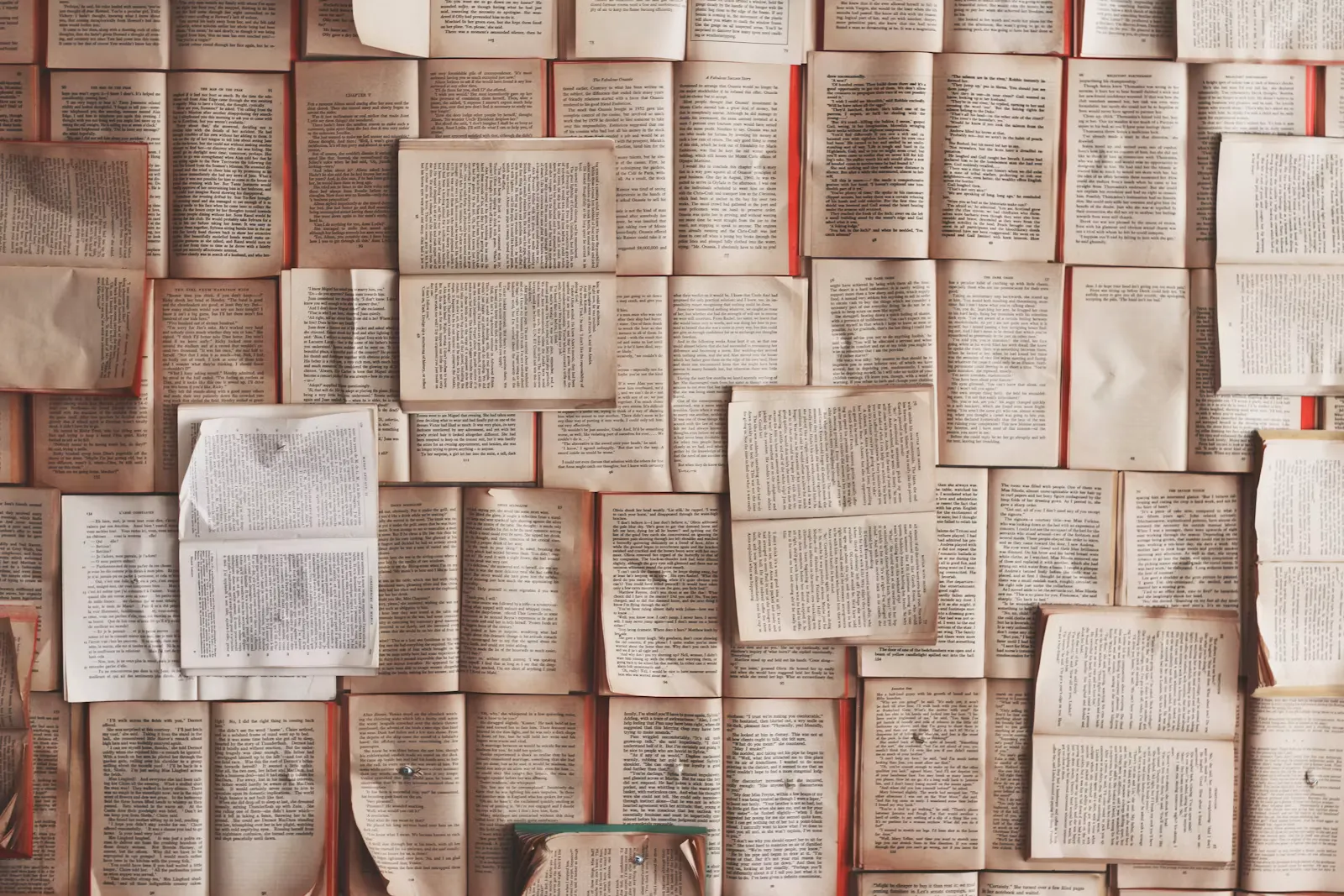 A wall covered in dozens of open books pinned side by side — how an unsorted Class 11 backlog feels before triage