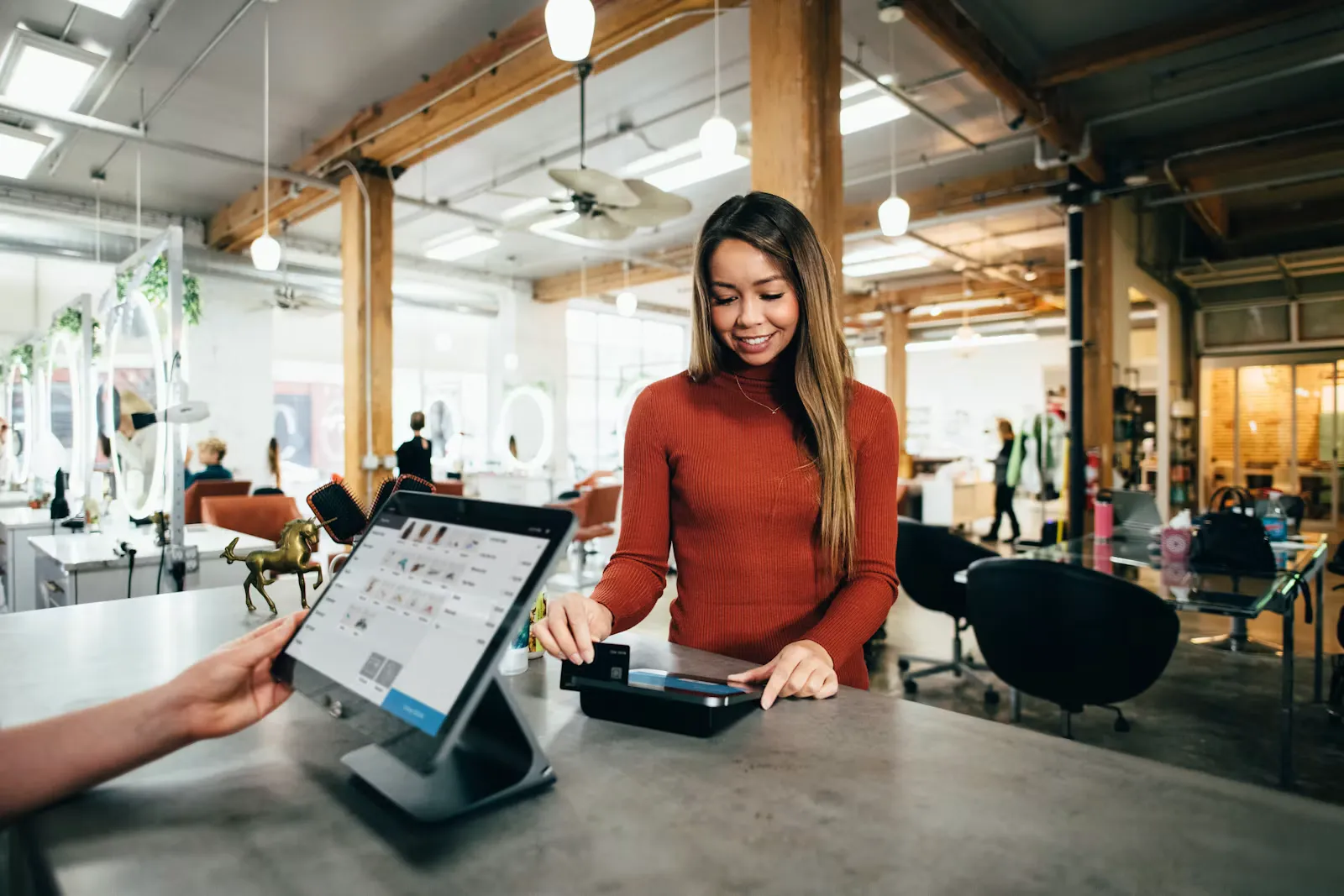 Customer paying a student worker at a café counter, a typical part-time service job for international students in a European university city