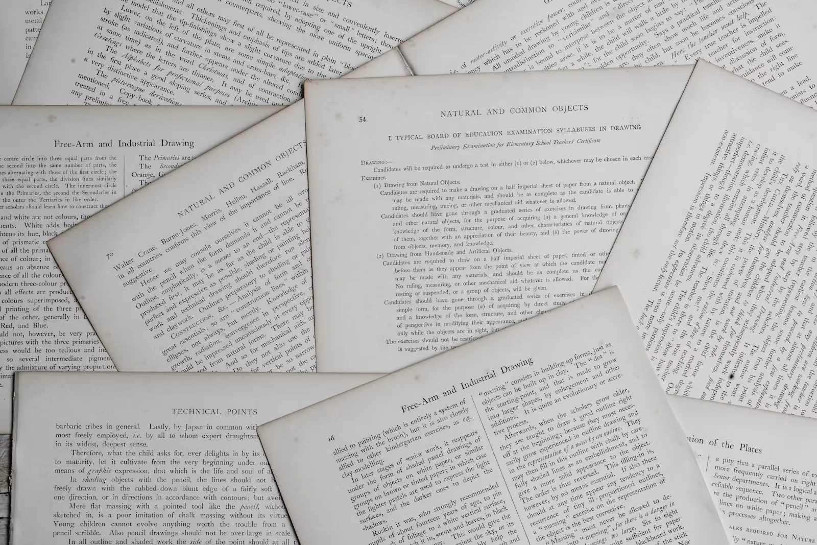 Overlapping pages from old printed examination syllabus documents, spread across a flat surface