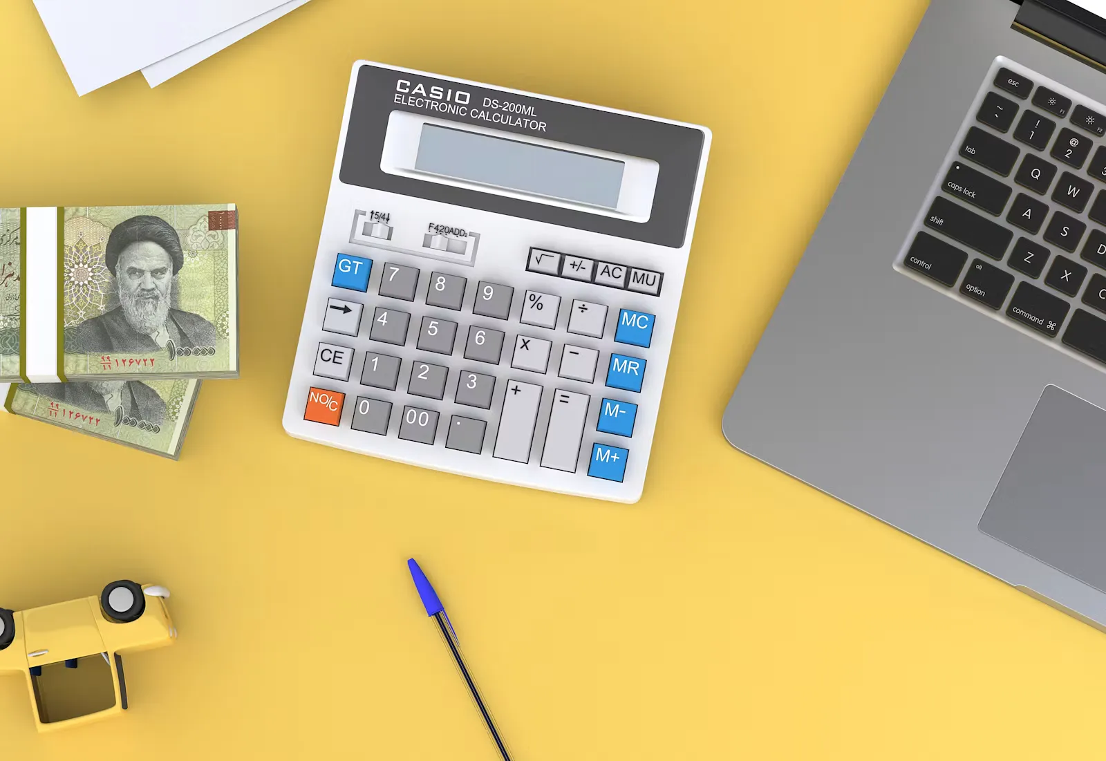 A calculator next to an open laptop, researching and budgeting for the cost of studying medicine abroad