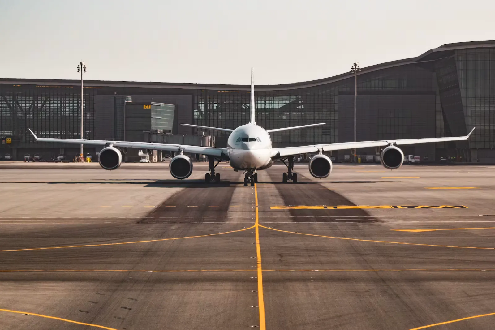 Passenger aircraft parked at an airport terminal, representing the choice between staying in Europe on an EU Blue Card or returning to India after MBBS