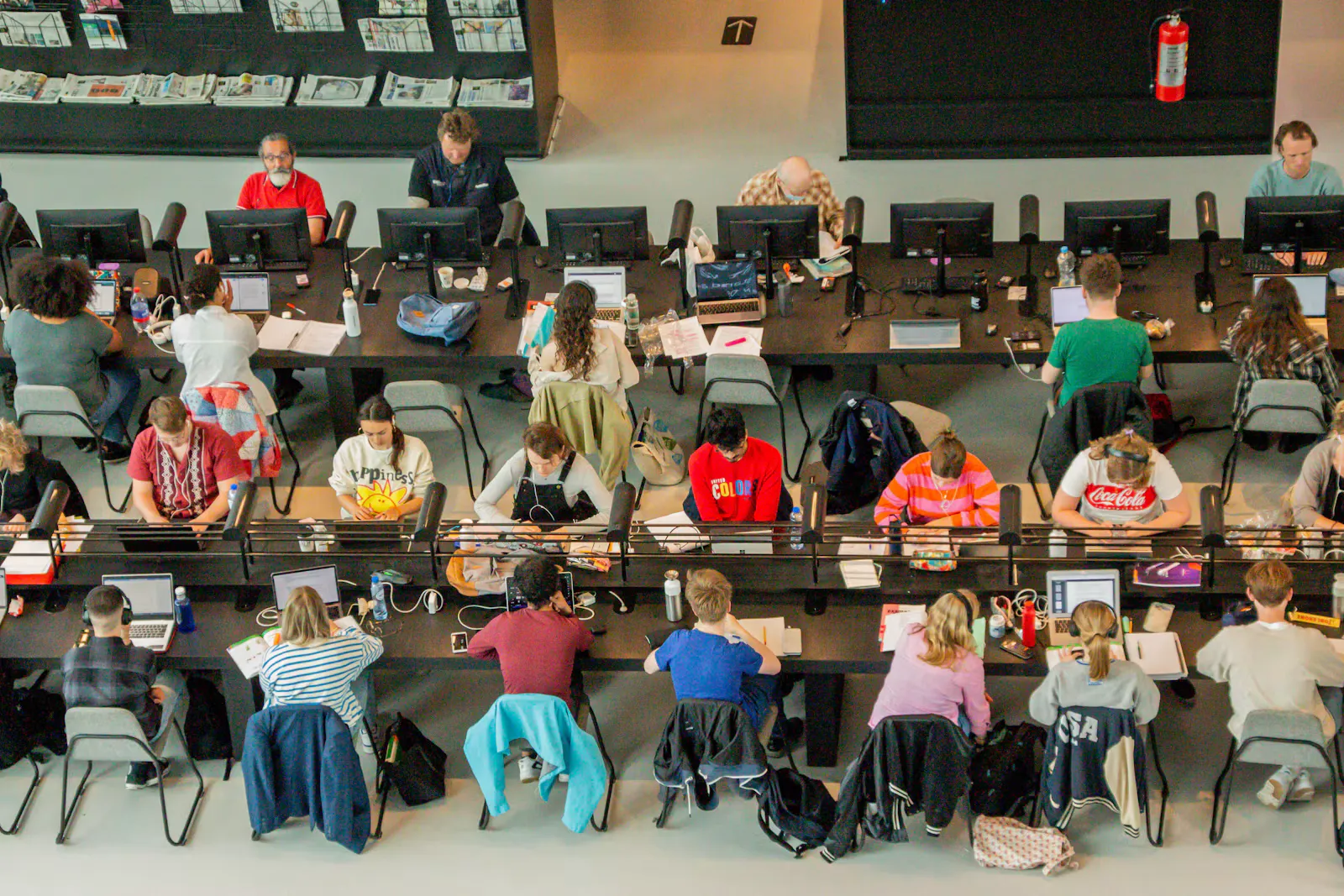Rows of students working at desks in a large hall seen from above, the kind of room where every candidate sits under the same NEET rules