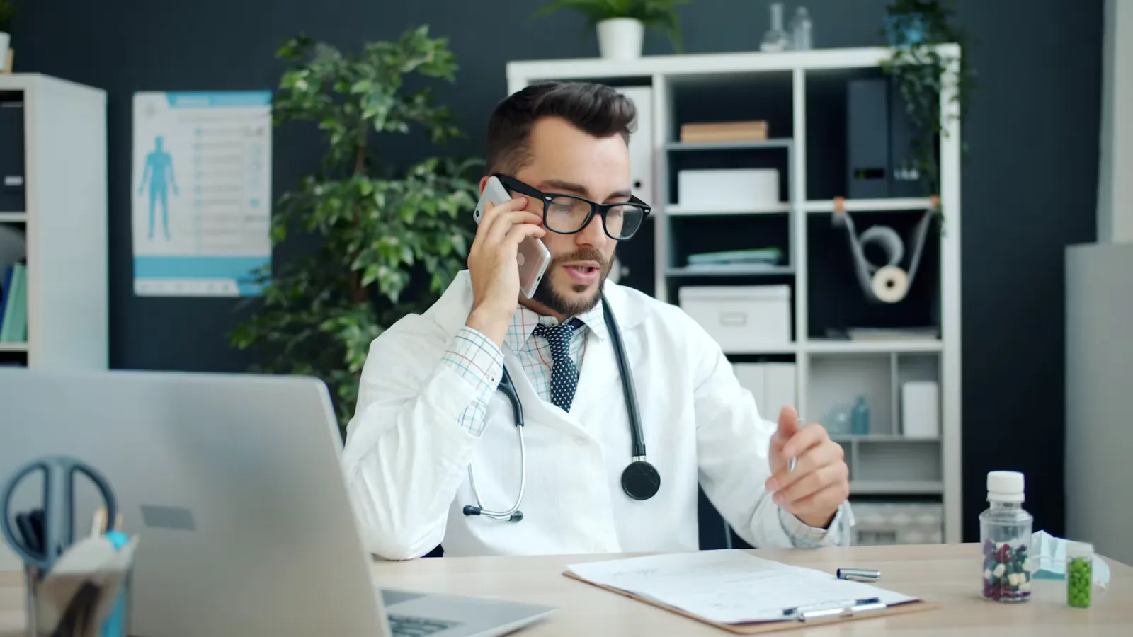 A doctor talking on the phone in his office