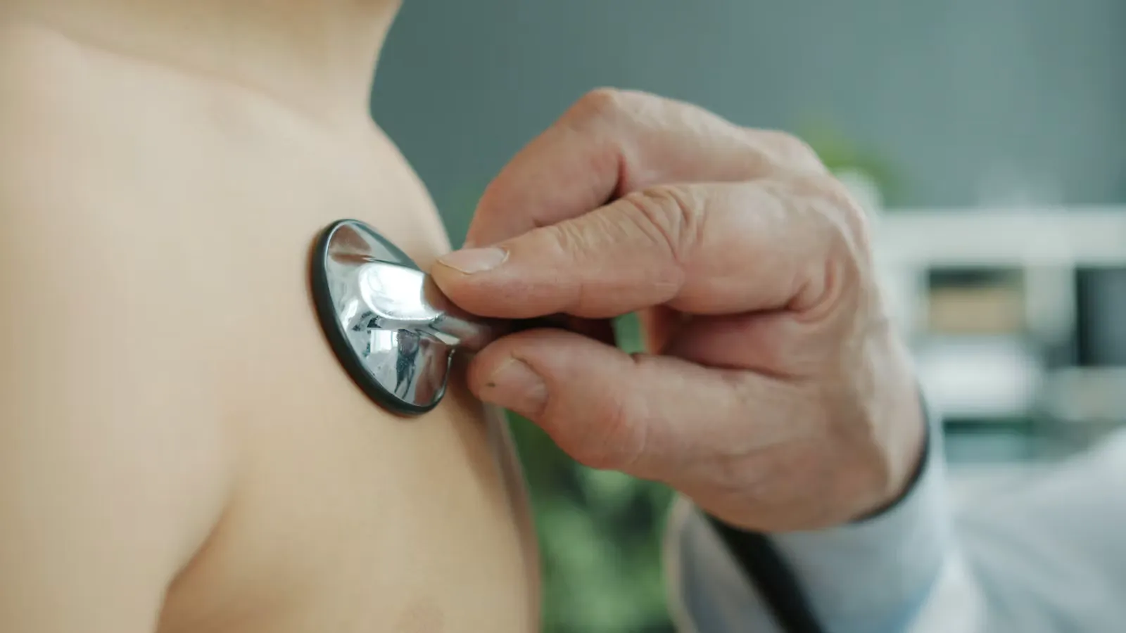 A clinician using a stethoscope to examine a patient's chest, the kind of supervised task performed during a PA practical phase abroad elective