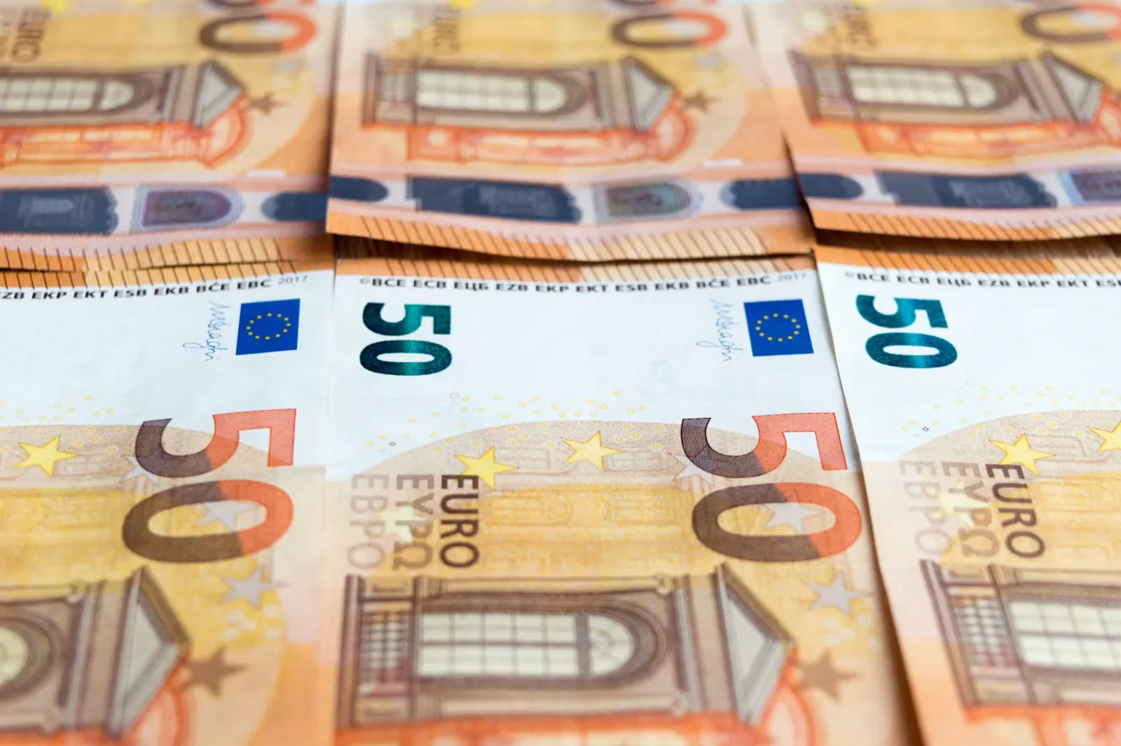 A fifty euro note lying on a wooden table