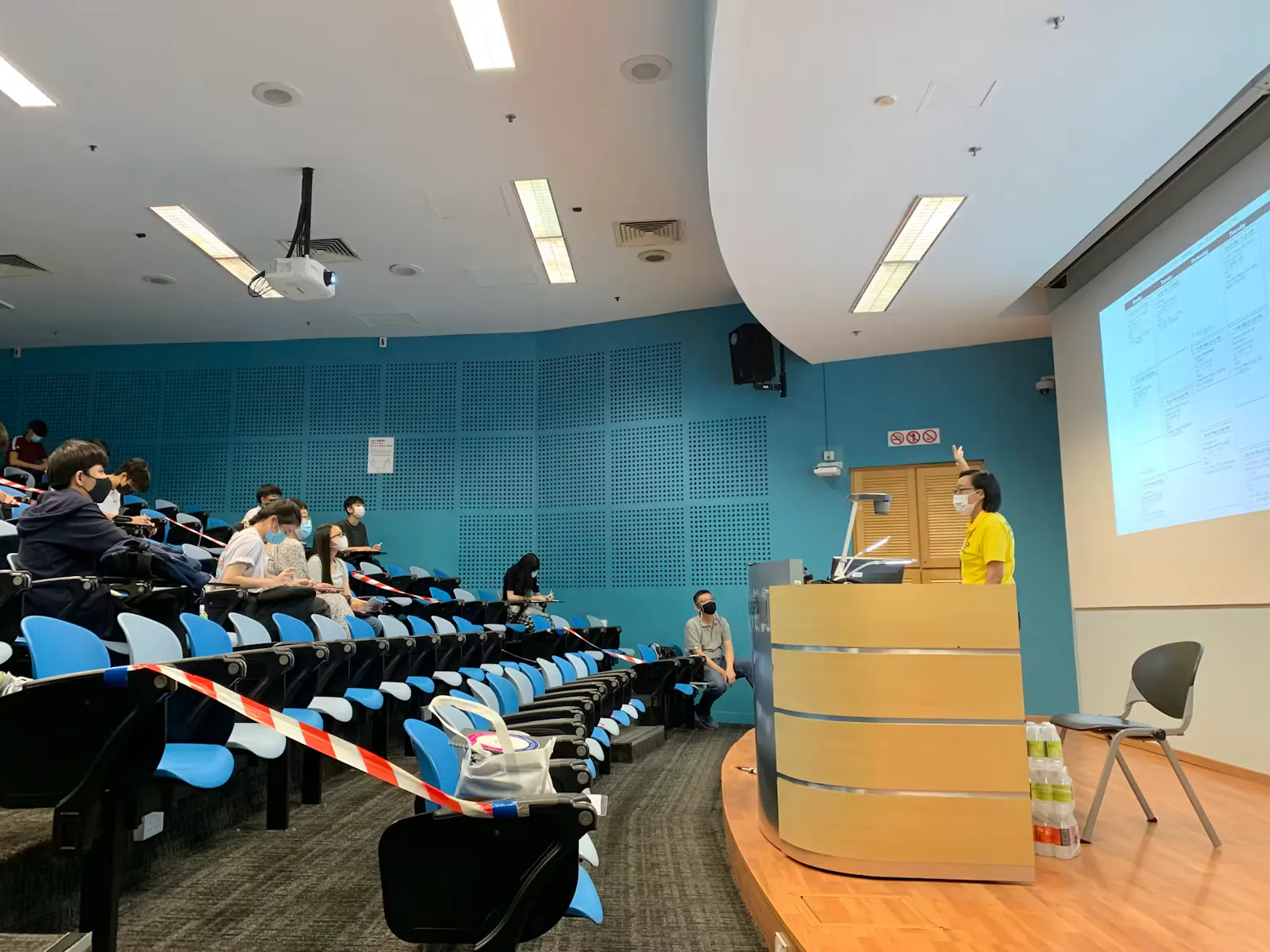 Students attending a lecture in a large modern lecture hall