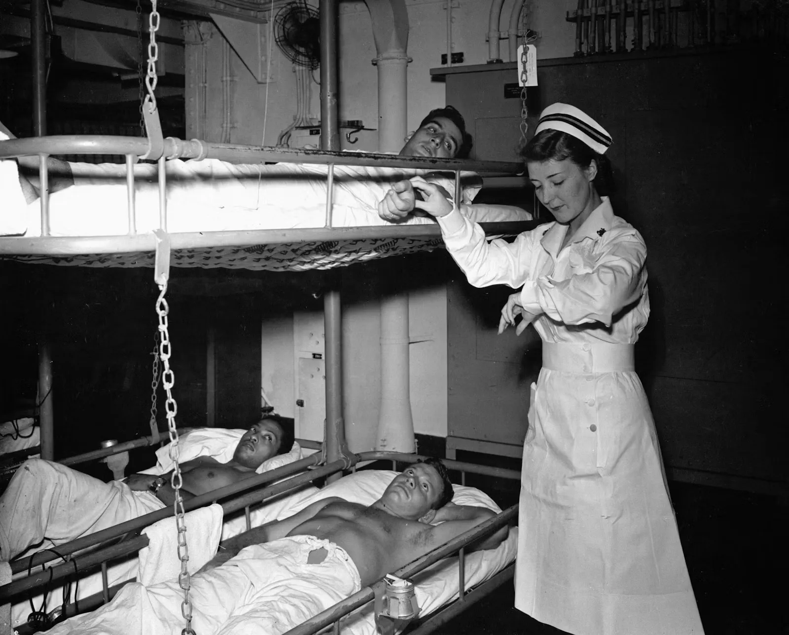Nurse attending to a patient on a hospital ward, representing the supervised bedside care students take on during a practical year abroad