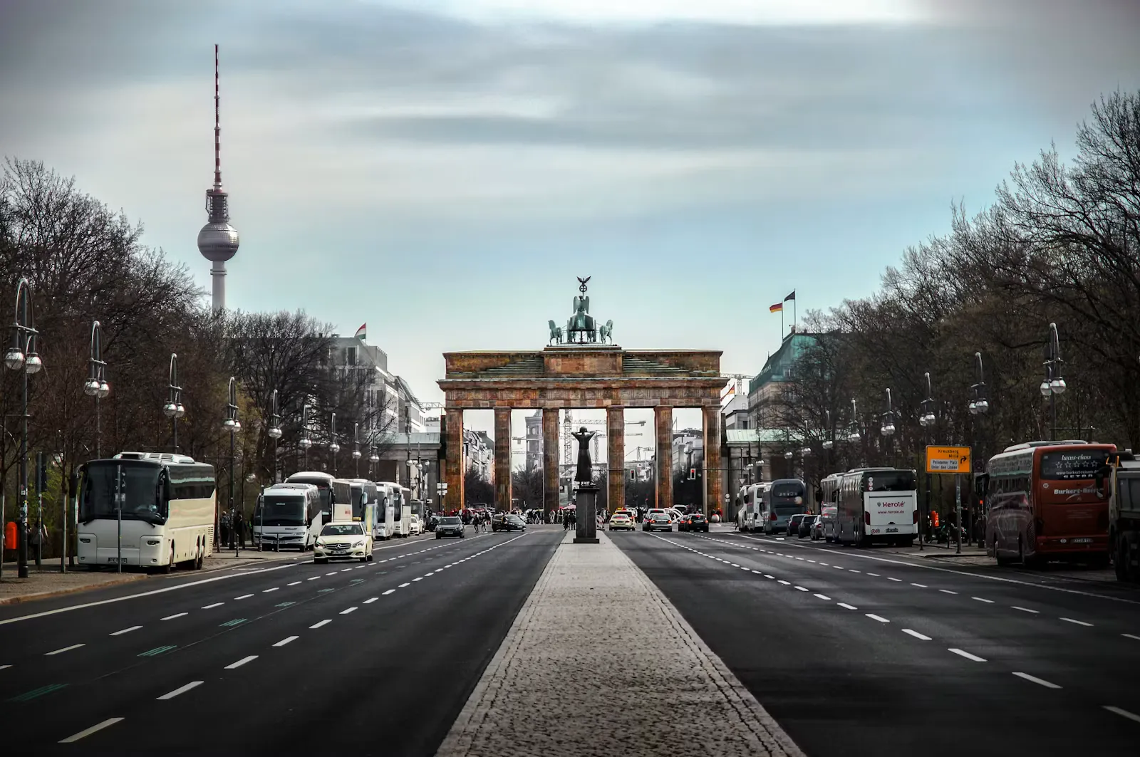 Brandenburg Gate and the Berlin TV tower under a cloudy sky in Germany, a destination for studying medicine abroad