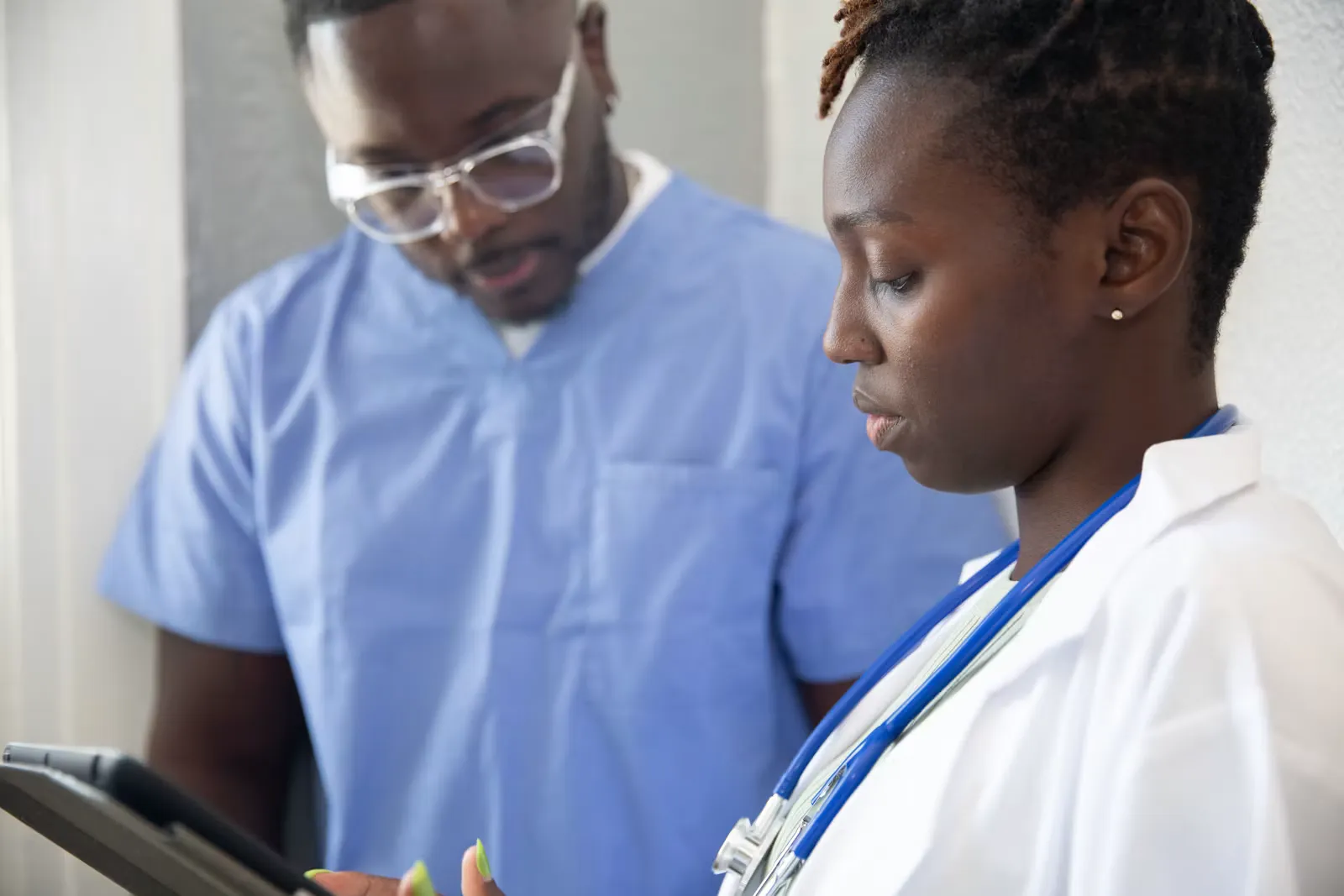 A doctor sitting with a patient during a consultation